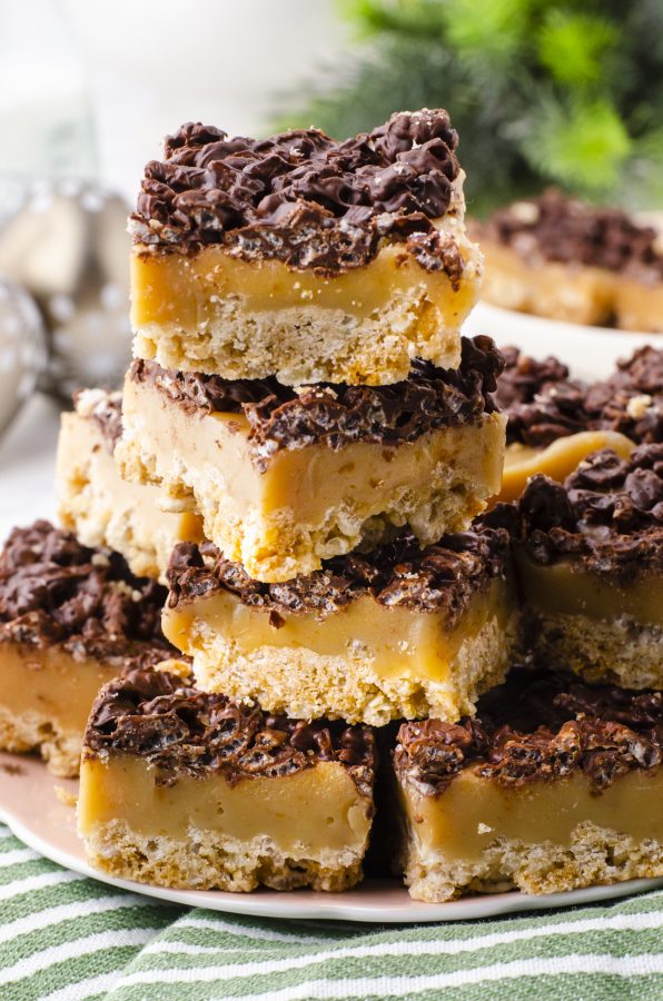 Caramel Chocolate Crispy Rice Bars stacked on a plate.
