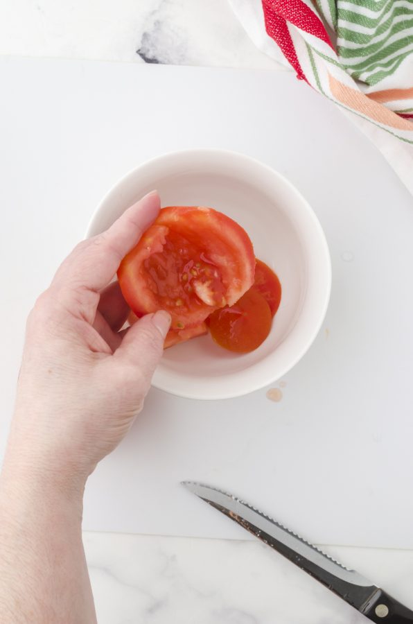 4.Scoop out the seedy area of the tomato area into a bowl (to dispose easily)