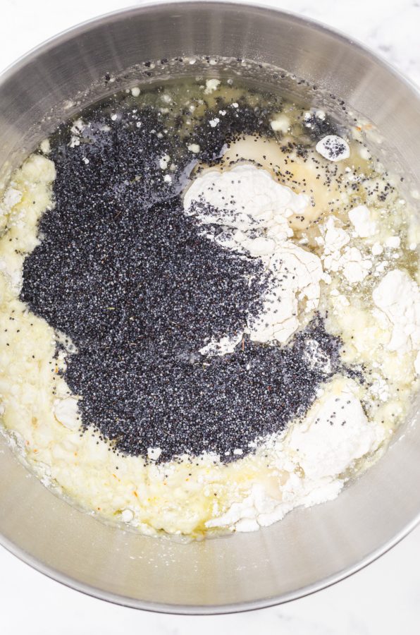Ingredients for poppy seed loaf cake in an electric mixer bowl.