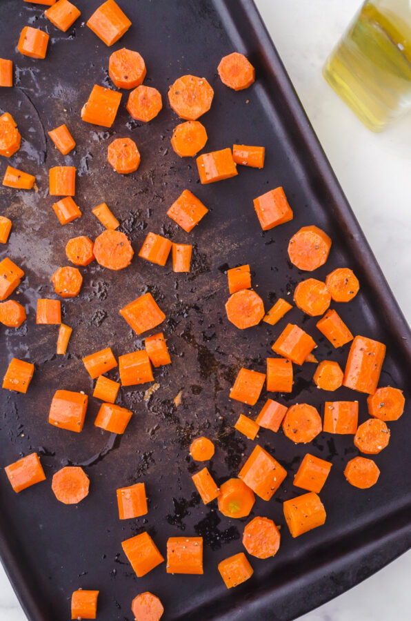Carrot chunks on a sheet pan.