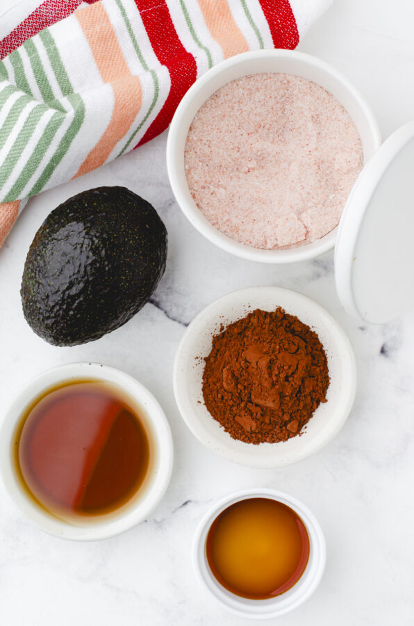 ingredients for chocolate avocado pudding with maple syrup and unsweetened cocoa powder
