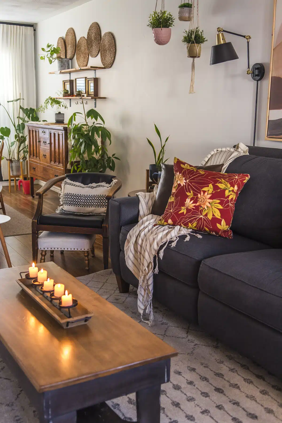 Candles lit on a coffee table next to a couch
