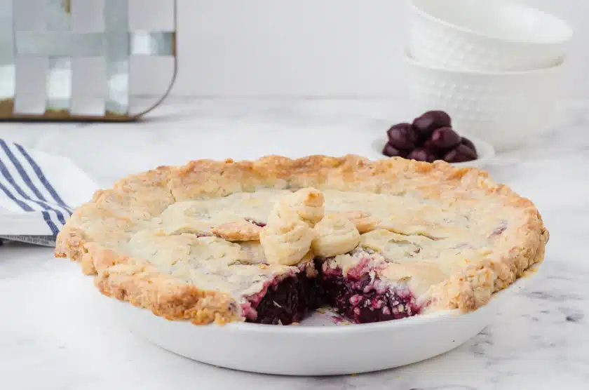 a cherry pie with a slice cut out of it