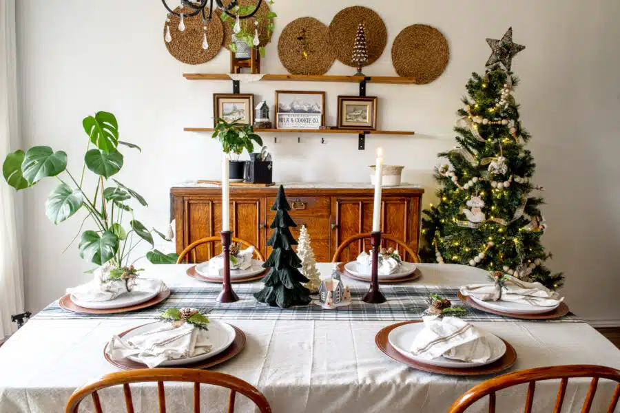 A table set in a dining room with a Christmas tablescape.