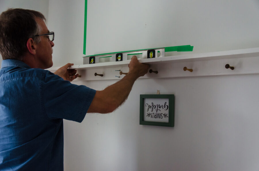 Using a level to make sure the shelf is level.