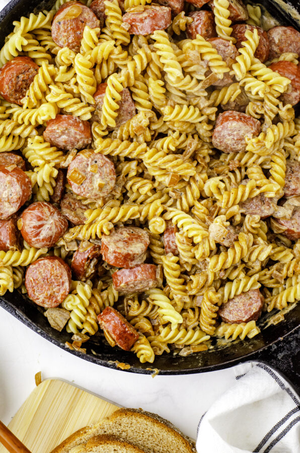 creamy farmer's suage and noodles recipe in a cast iron skillet