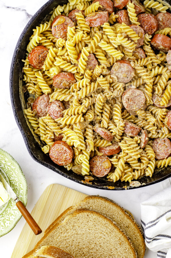 Farmer's sausage and noodles with cream gravy in a cast iron skillet