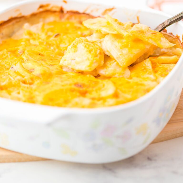 a casserole dish with scalloped potatoes with mushroom soup and cheesey topping