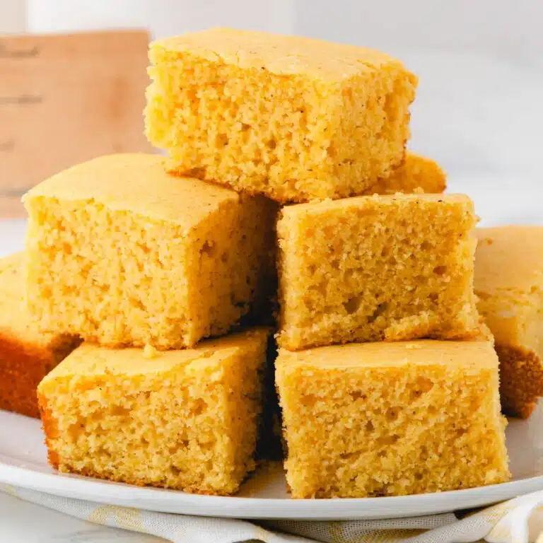 A stack of cornbread pieces on a serving plate.