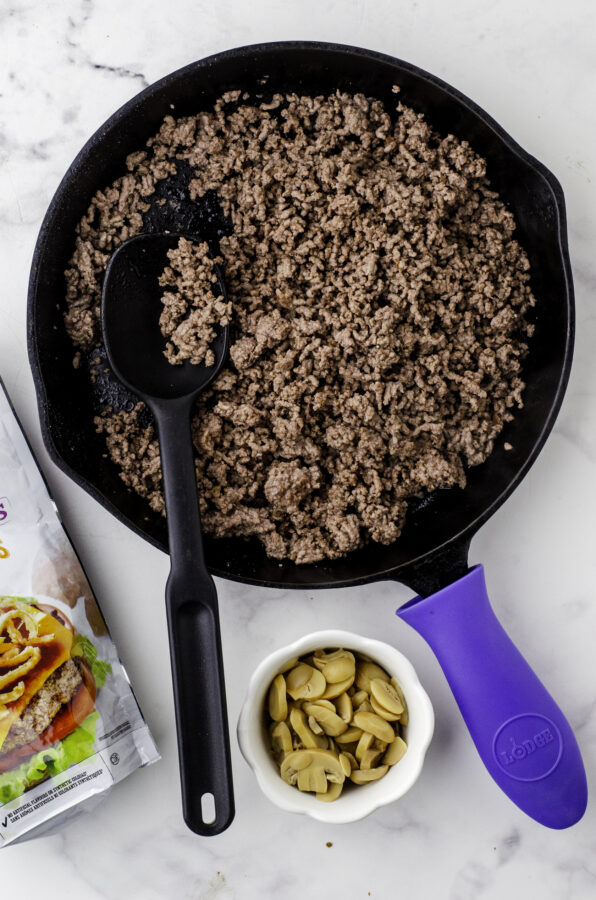 Browned ground beef in a skillet for hamburger biscuit casserole