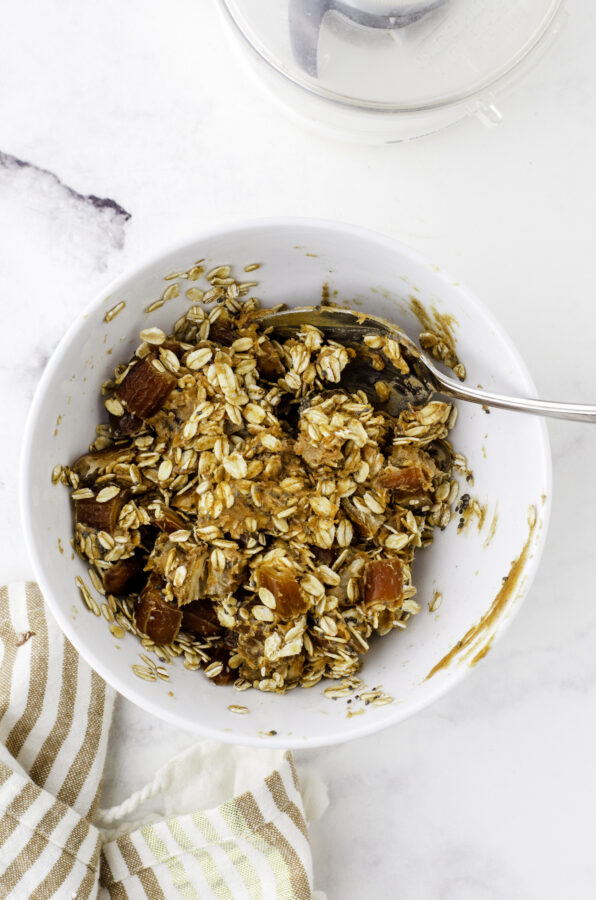 Date ball ingredients being stirred together in a bowl.