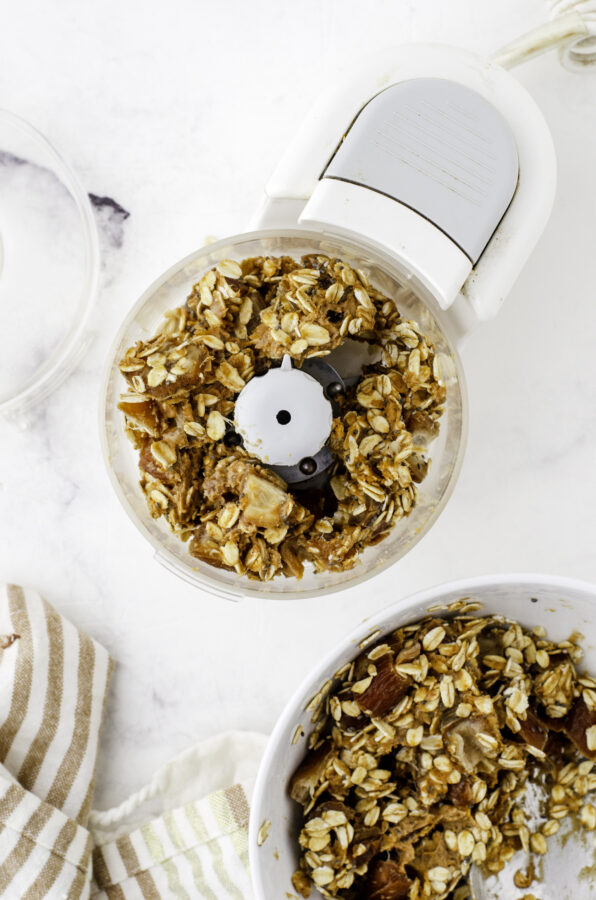 Date ball ingredients in a food processor before it is processed.