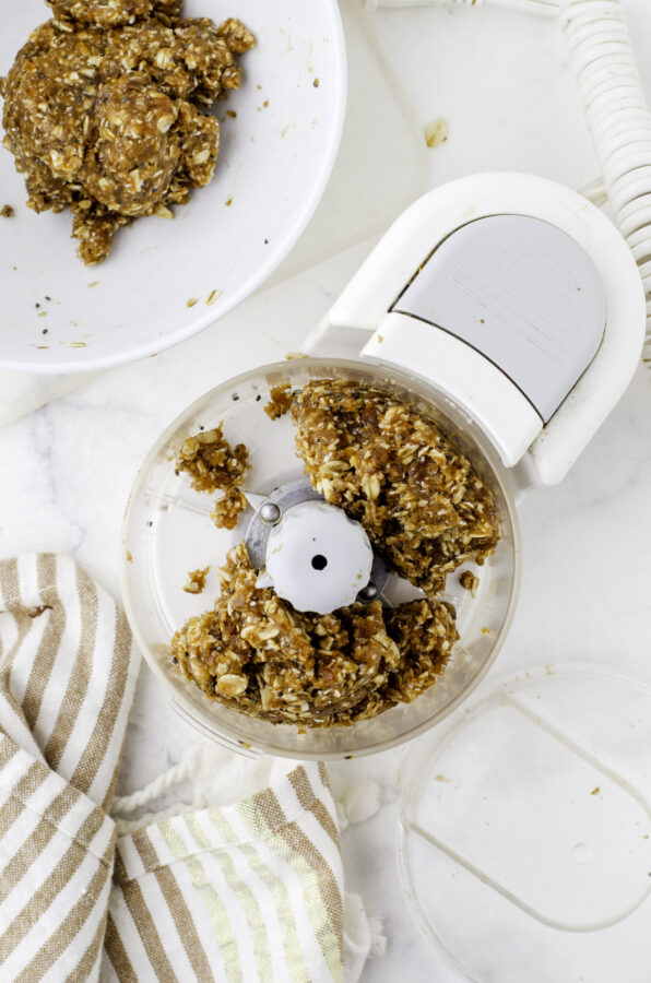Date ball ingredients in a food processor after it has been processed.