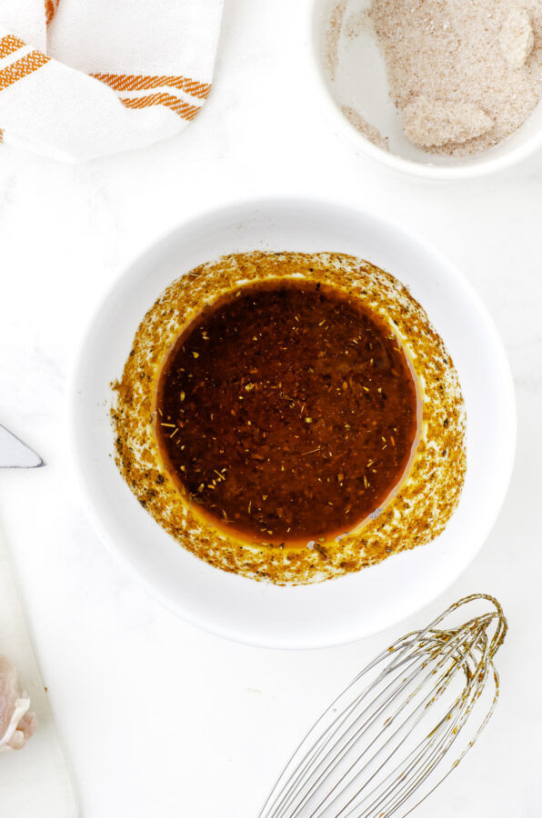 Mexican chicken marinade ingredients stirred together in a bowl.