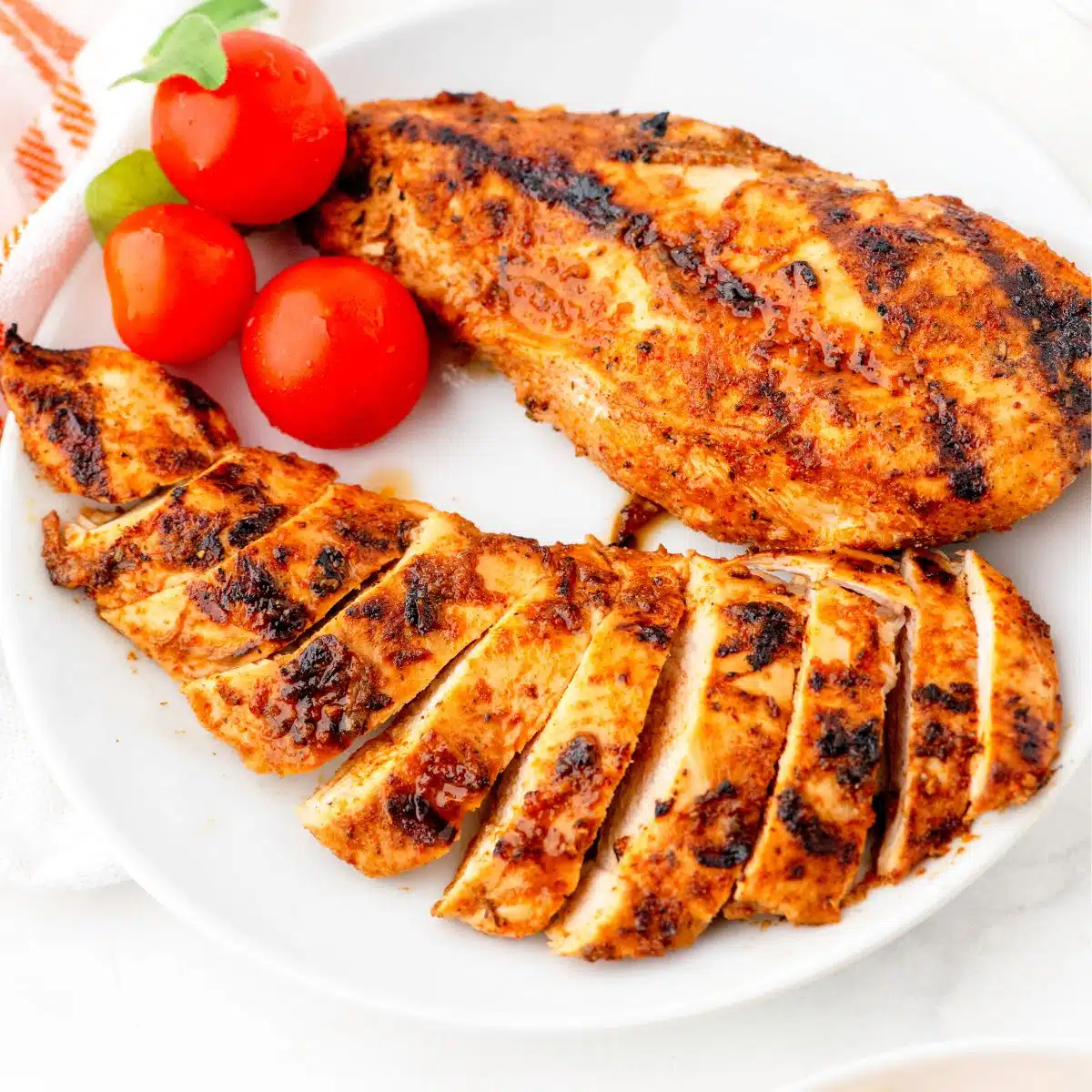Mexican Chicken breasts that have been marinaded in Mexican Chicken marinade. They've been grilled and sliced and placed on a plate.