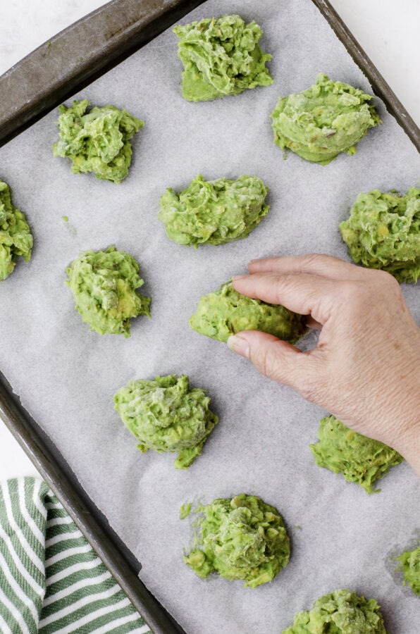 After a few hours in the freezer, the avocado portions will be solid and can be popped off with your fingers.