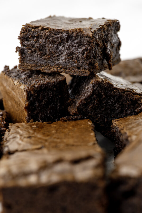Sourdough brownies stacked up so you can see how soft and fudgy they are inside.