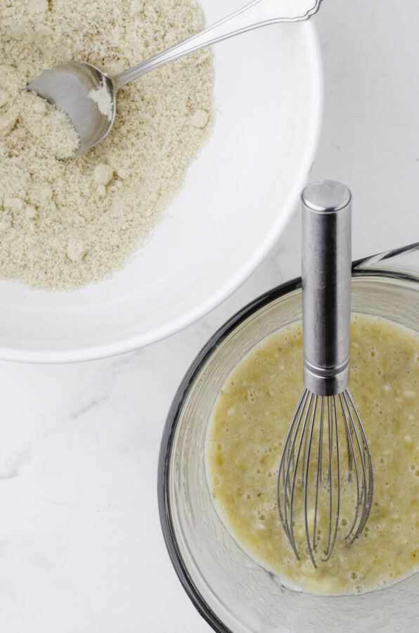 A bowl with the dry ingredients and a bowl with the wet ingredients side by side.