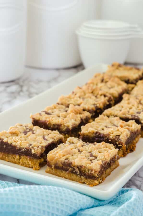 Peanut Butter Fudge Bars (can't leave alone bars) arranged on a rectangular serving plate.