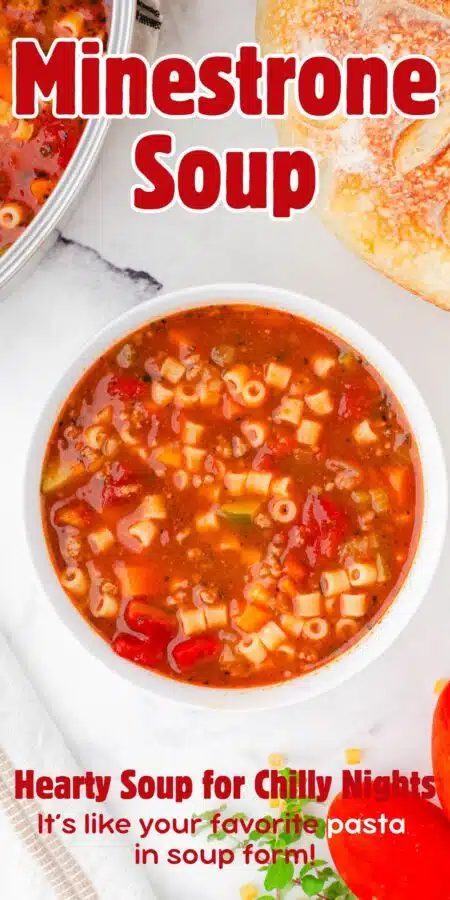 Bowl of minestrone soup with crusty bread beside.