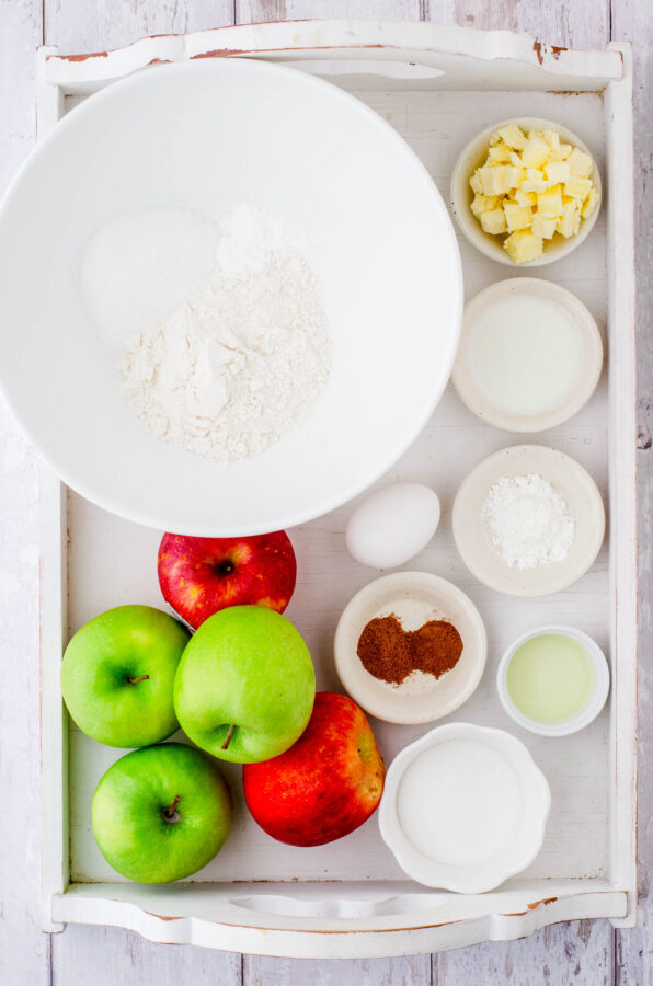 Ingredients for this apple cobbler recipe in a large wooden tray.