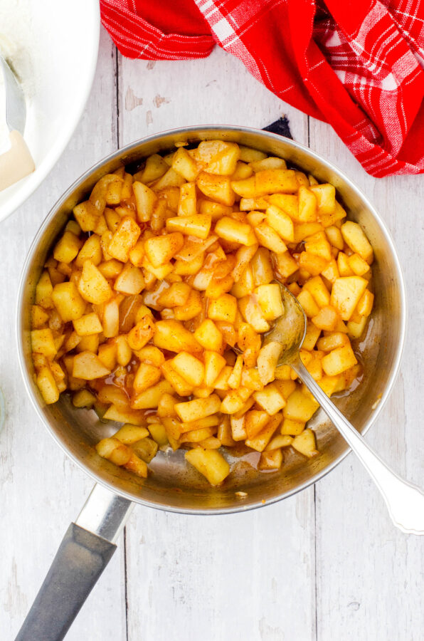 Hot apple pie filling for apple cobbler in a medium sized saucepan.