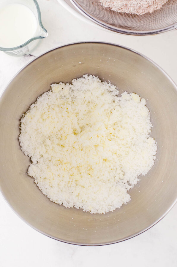 Butter and sugar creamed together in a stand mixer bowl.