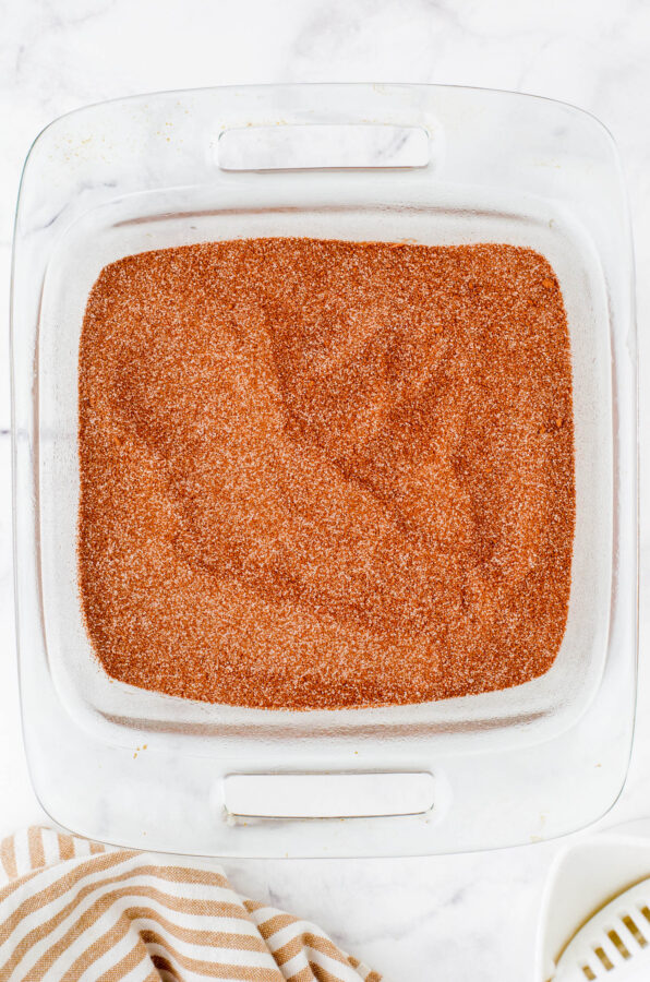 Topping mix on a pan of chocolate pudding cake batter.