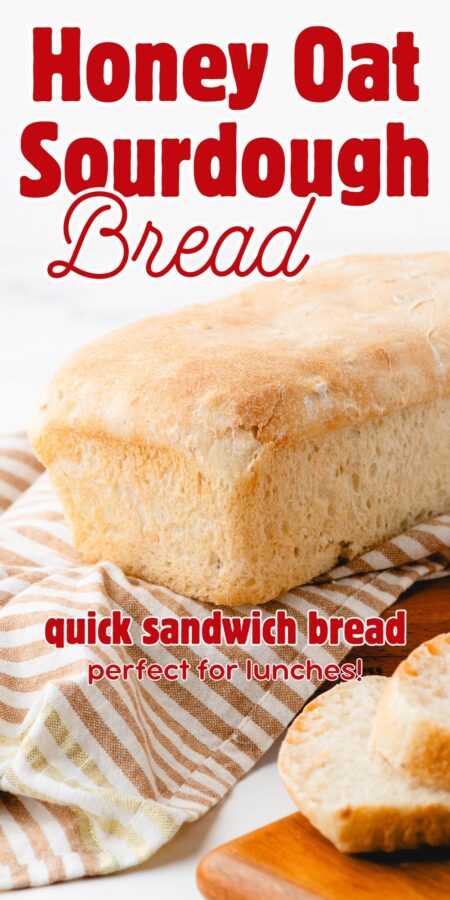 A loaf of sourdough sandwich bread on a striped cloth