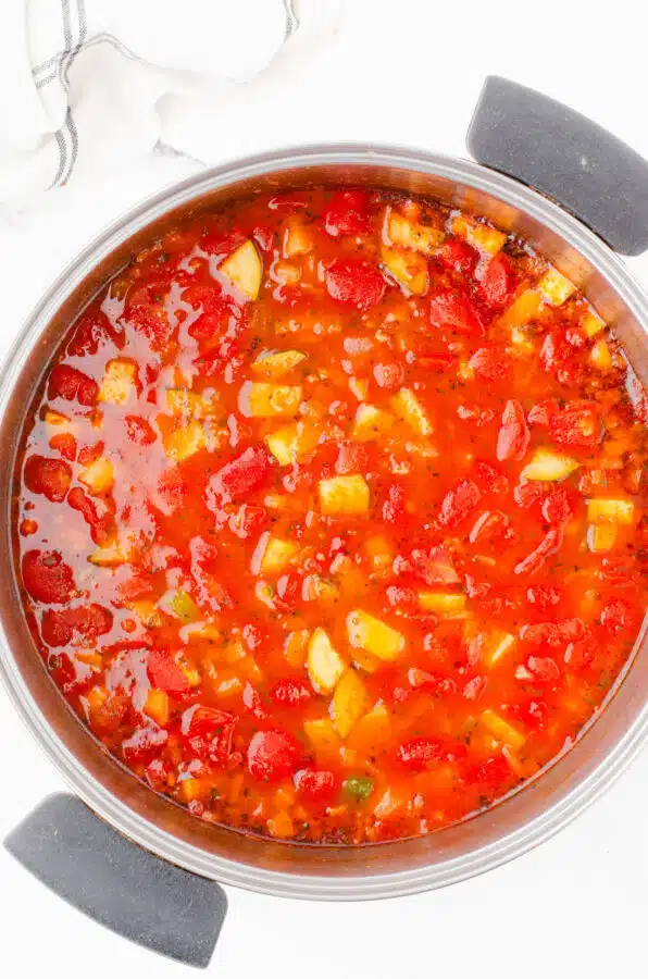 Minestrone soup in a large stock pot before the pasta is added to it.