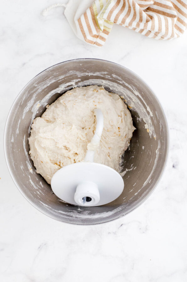 Honey oat sourdough bread dough after it has been mixed together with an electric mixer fitted with a dough hook.
