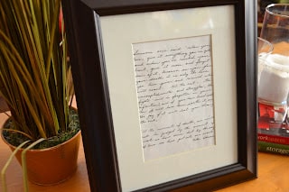 handwritten note in a picture frame with a mat