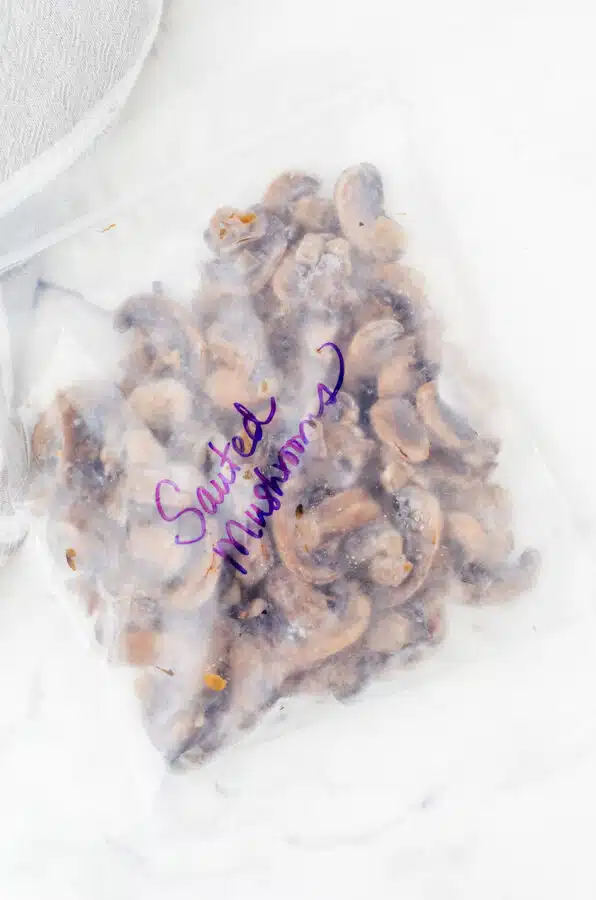 Frozen mushrooms in a zipper top freezer bag marked with the label "sauted mushrooms".