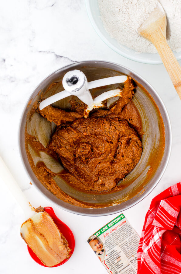 The creamed butter, sugar, and molasses in a mixing bowl for chewy gingersnaps recipe.