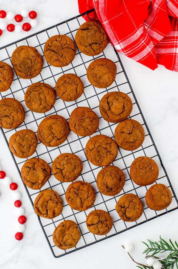 Gingersnaps cookies cooling on a wire baking rack.