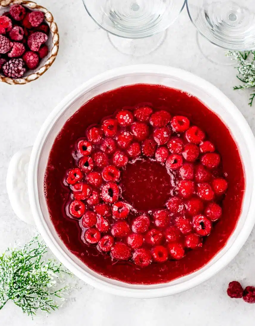 red Christmas punch in a punch bowl with an ice ring