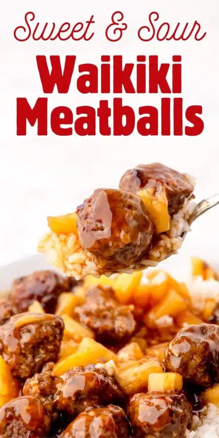 Forkfull of sweet and sour meatballs with pineapple tidbits over a bowl of waikiki meatballs over rice.