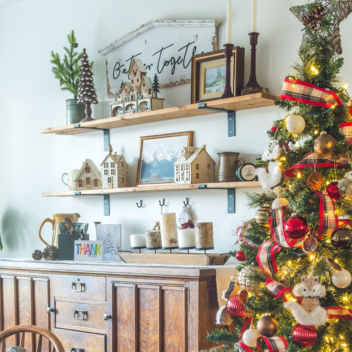 Christmas tree by an antique buffet