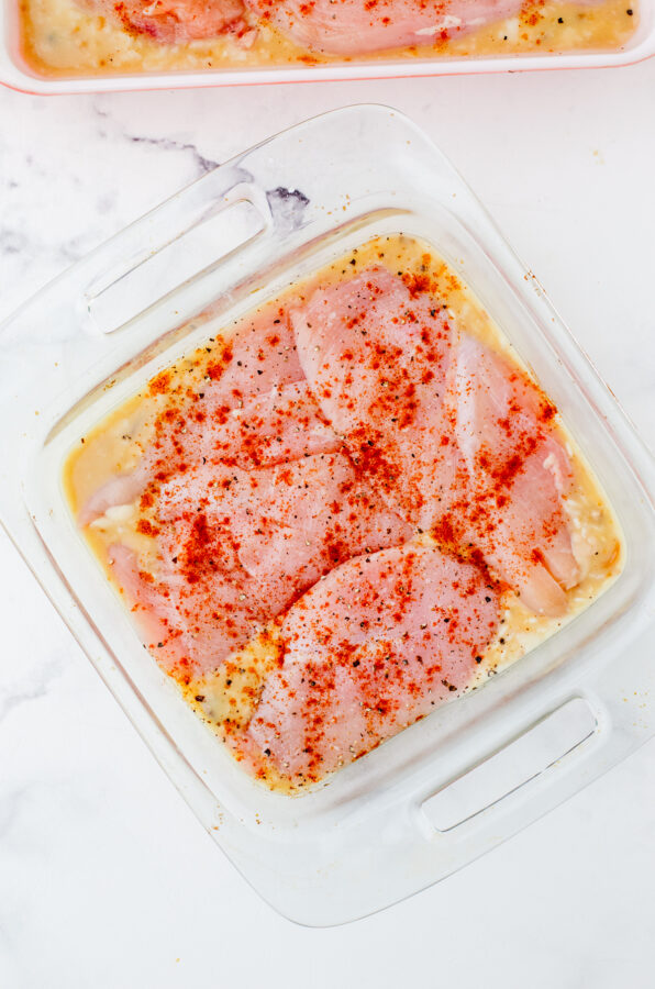 Chicken rice pilaf assembled and ready to bake in a baking dish.