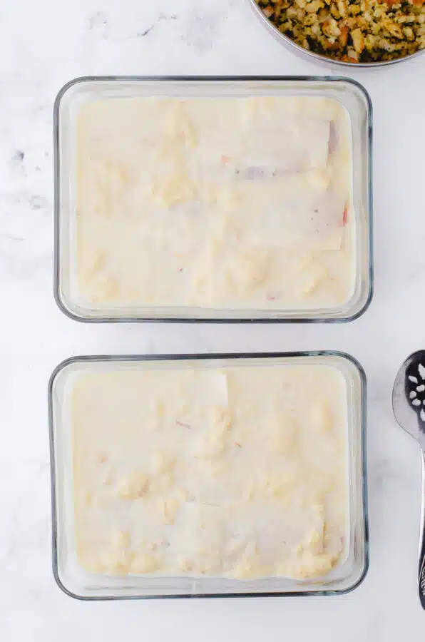 Soup and milk mixture poured over the chicken with swiss cheese on it.