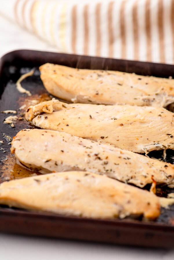 Lemon chicken in a stoneware baking dish.