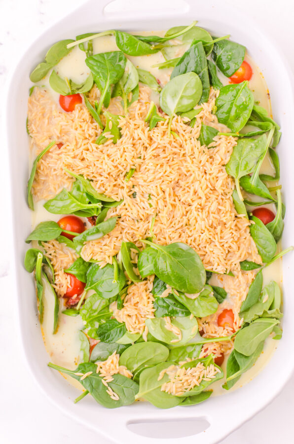 Fresh spinach and dried orzo layered over the chicken mixture