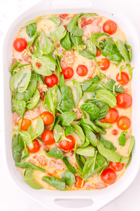 Chicken broth and cream poured over all in a baking pan.