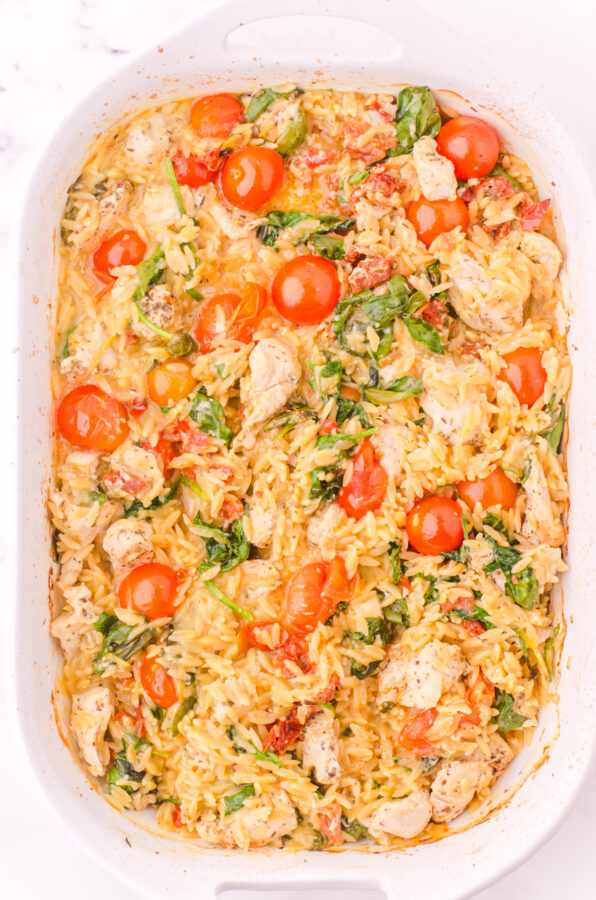 Baked chicken orzo casserole before parmesan cheese has been added.