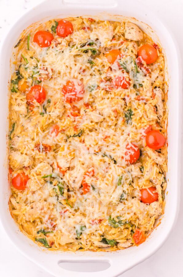 Baked orzo chicken casserole with parmesan cheese on the top.