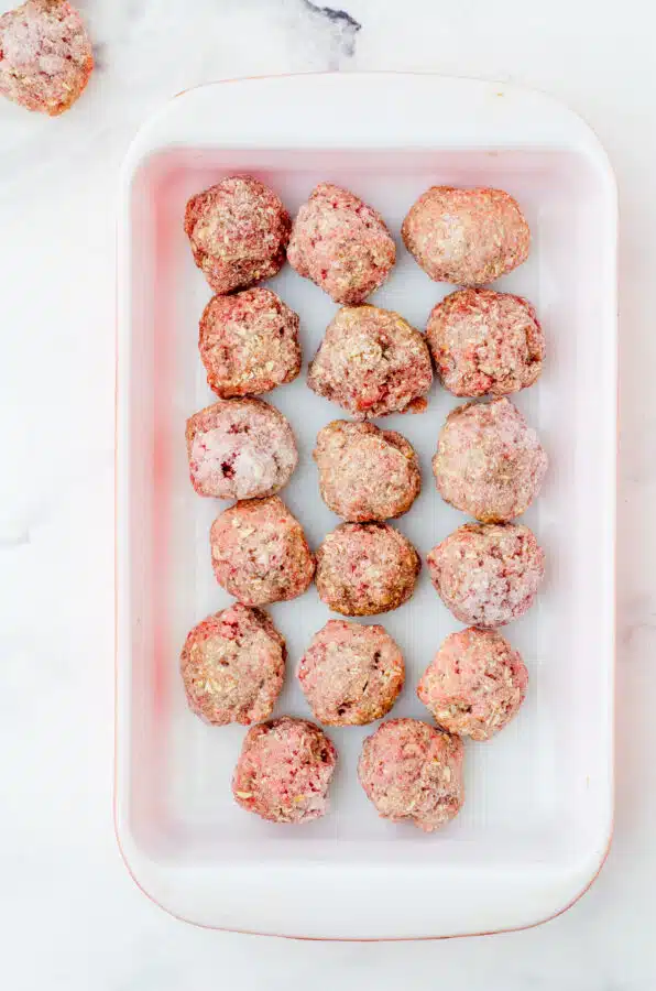 Frozen meatballs in baking dish.