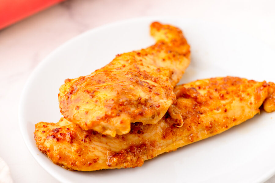 Honey mustard chicken breasts on a serving plate.