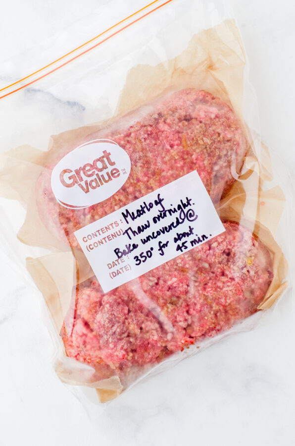2 frozen meatloaves in a zip top freezer bag with label on the front.
