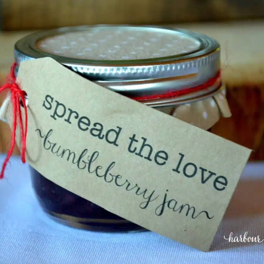 a jar of jam for a bridal shower favor with a tag that says "spread the love"