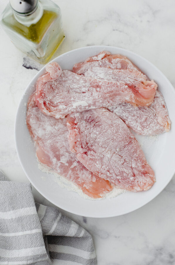 Chicken breasts that have been dredged in flour.